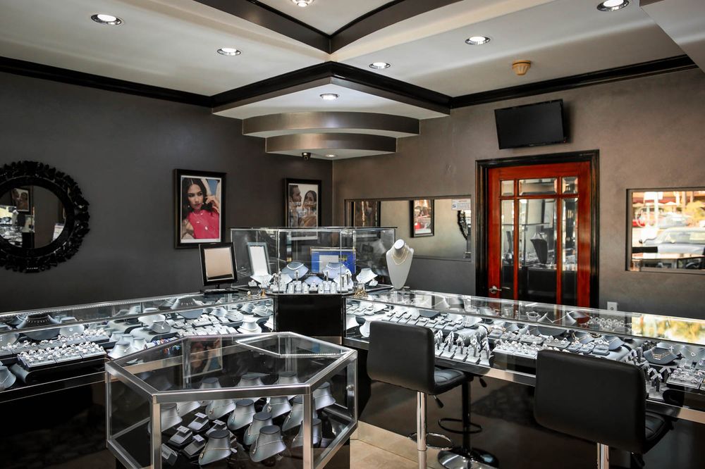 Modern jewelry store interior with elegant glass display cases.